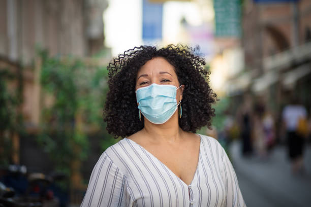 istock Woman with protective mask on face walking trough city. 1316904887