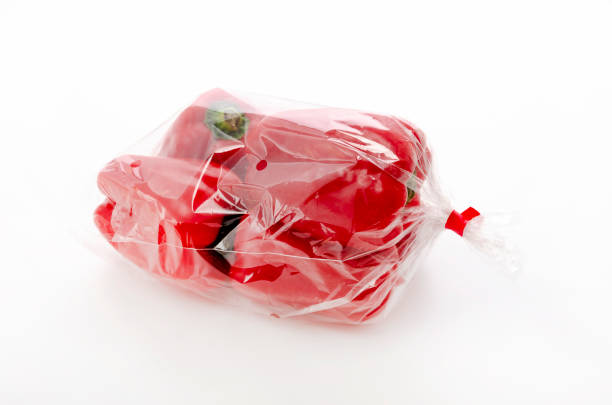 Red bell pepper in plastic bag on white background