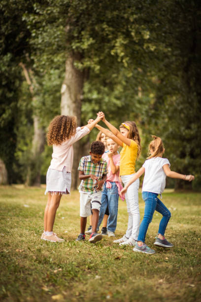 Childhood is best time of life. Large group of school kids having fun in nature. playing children stock pictures, royalty-free photos & images