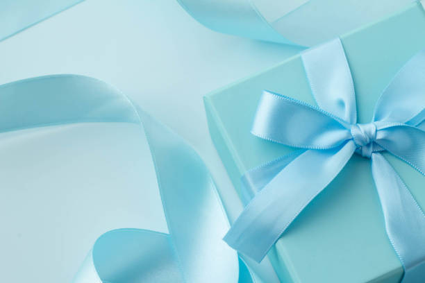Light blue ribbon, gift box and plain background, pink alstroemeria gift image