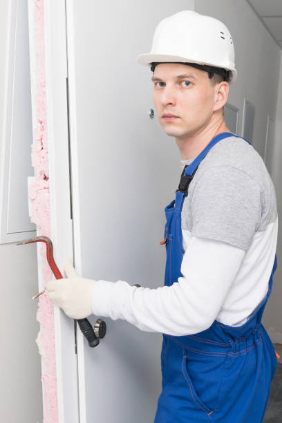 istock a construction worker in a helmet dismantled the door using a special tool 1316913858