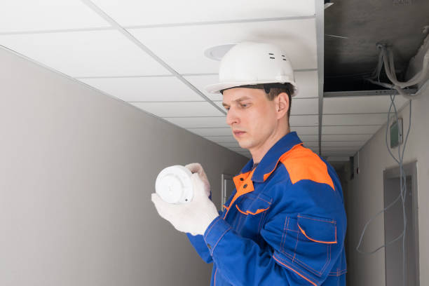 istock a worker checks the smoke and fire sensor for malfunction 1316913881