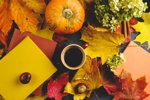 istock Coffee mug, autumn maple leaves, pumpkin and colourful books 1316913936
