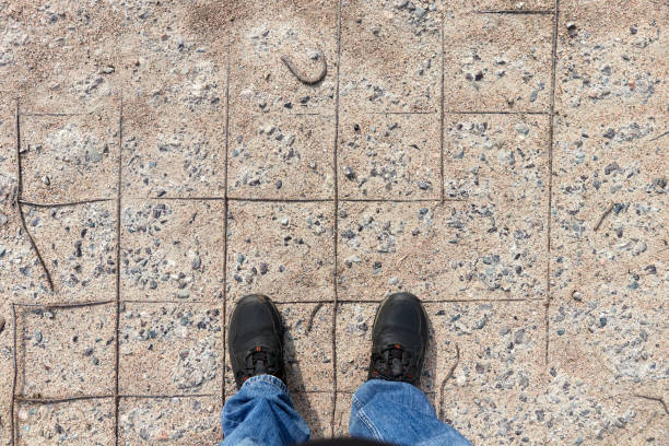 istock man standing on old crumbling concrete slab with rusty rebar 1316917001