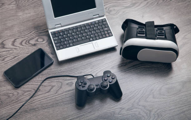 istock Virtual reality goggles, joystick, laptop, smartphone. 1316921417