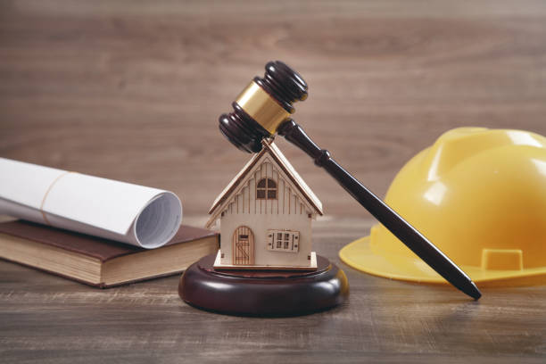 istock Judge gavel, house model, safety helmet, book and document. 1316921497