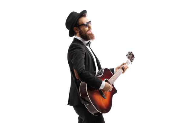 istock Man walking and playing an acoustic guitar 1316922344