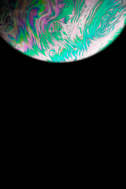 istock Soap bubble. Abstract galaxy background with globe planet earth in universe space with sunlight on dark background. Concept of apocalypse, armageddon, doomsday. 1316923654