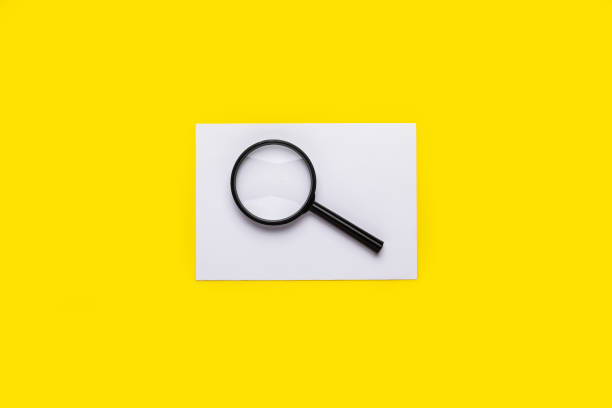 istock magnifying glass and blank white sheet on a yellow background 1316924401