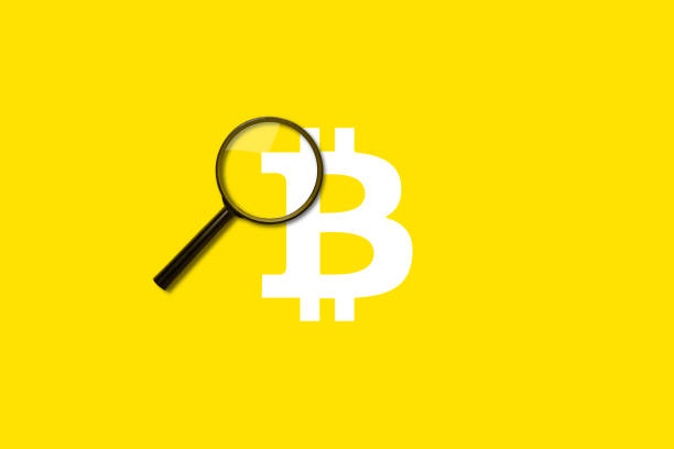 istock magnifying glass loupe search on yellow background. Added bitcoin sign 1316924457