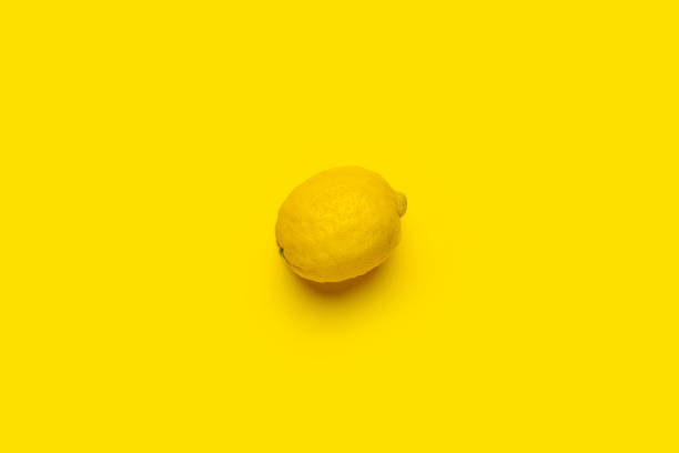 istock whole ripe lemon on a bright yellow background. Top view, flat lay 1316924691