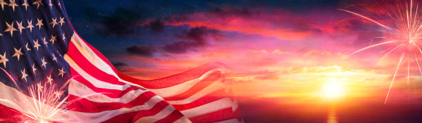 istock American Flags At Sunset With Fireworks - Abstract Defocused Composition 1316927688