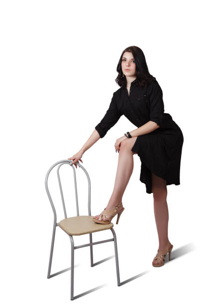 istock young woman in black dress posing standing in studio 1316927781