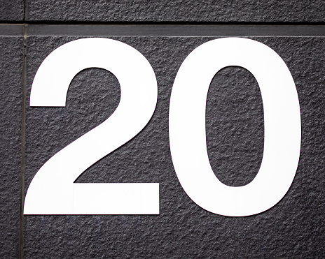 Close-up of the Number 20 on a wall.