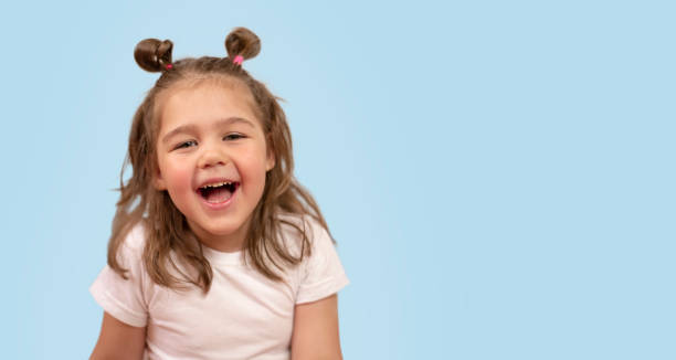 istock cute girl smiles on a blue background 1316931747