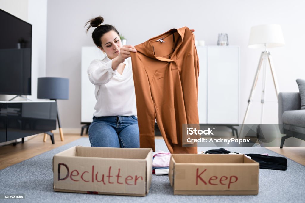 Woman Decluttering Clothes, Sorting Woman Decluttering Clothes, Sorting And Cleaning Up Closet Stock Photo