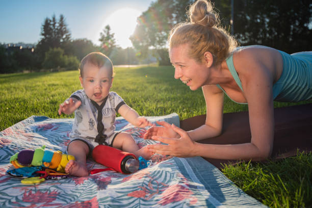 istock Little boy playing while his mother exercising in the park 1316932032