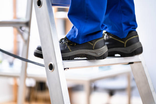 istock Man In Shoes Climbing Step Ladder. Safety 1316933096