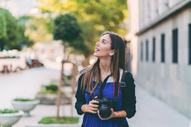 istock Woman on vacation taking photos 1316934346