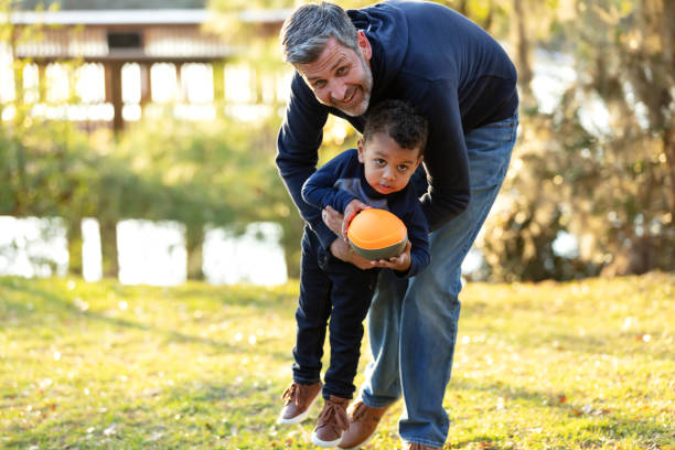 istock Father with his mixed race son playing at the park 1316939044