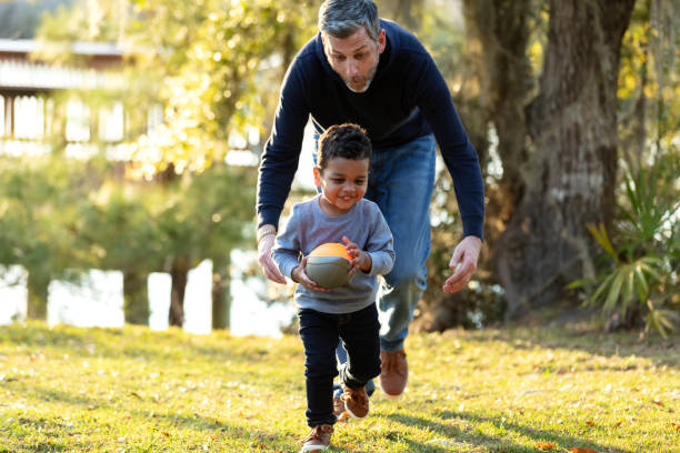 Father with his mixed race son playing at the park