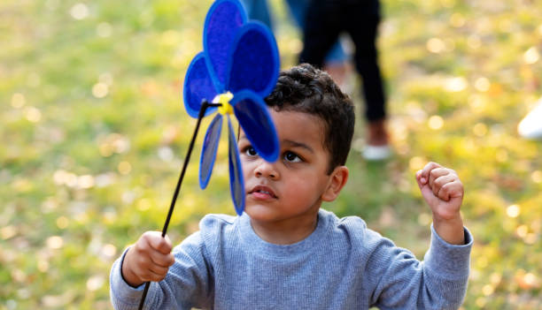 istock Mixed race boy at the park with pinwheel toy 1316939155