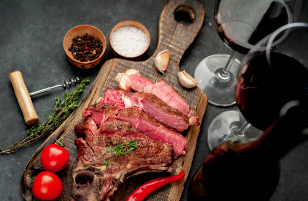 istock grilled beef steak and wine bottle with glasses on stone background 1316940921