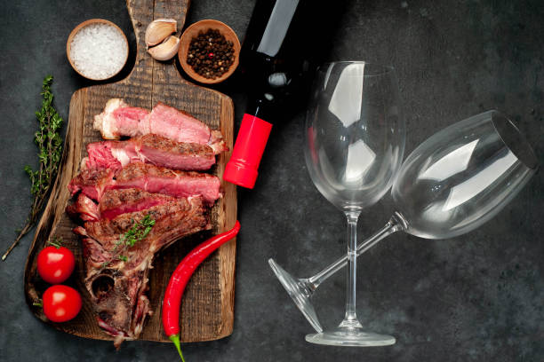 istock grilled beef steak and wine bottle with glasses on stone background 1316940923
