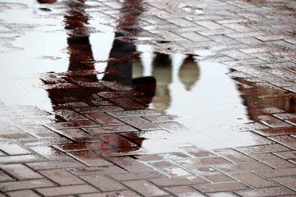 istock Rain in city, puddle on a street 1316944961