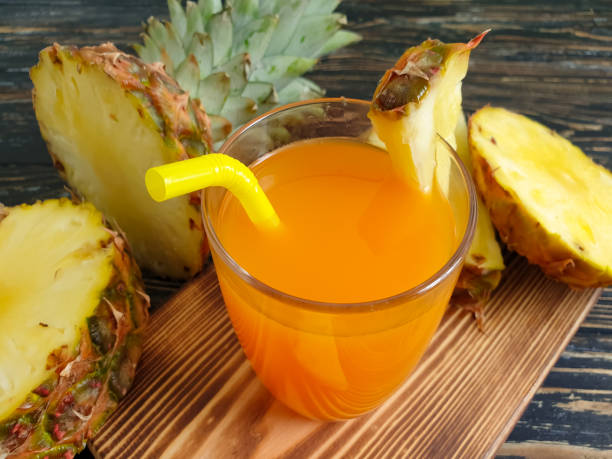 istock fresh juice, pineapple on wooden background 1316948480