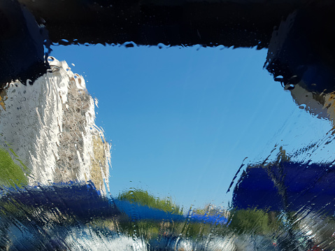Car Wash Abstract Splash Water Drop Wave Pattern Windshield View from Inside Washing Car Window Clean Blue Sky Distorted Building Tunnel Canopy Garage Copy Space Close-Up
Design template for banner, flyer, card, poster, brochure