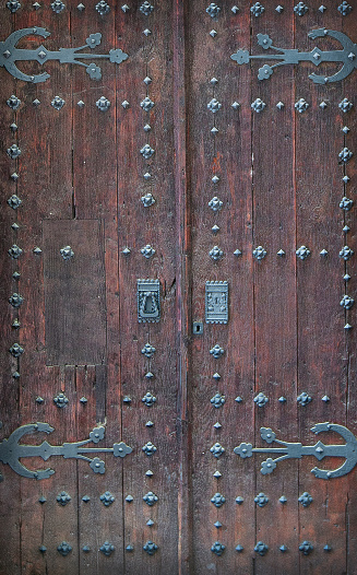 The antique wooden doors to the church
