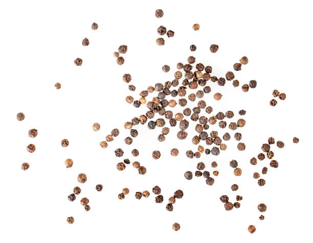 istock balck pepper isolated on white background. Black peppercorns macro closeup top view 1316951978