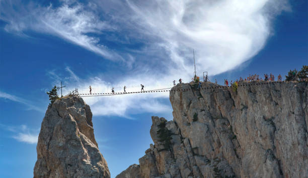 istock Beautiful landscape with mountains, rope ladder and blue sky. 1316952598