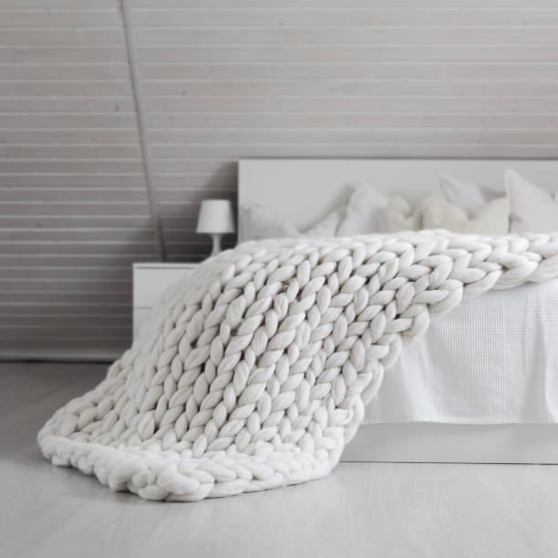 istock White nordic bedroom interior with knit plaid 1316952775