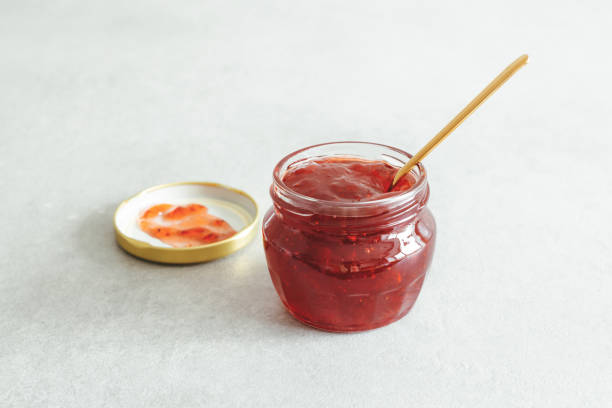 istock Open jar with homemade strawberry jam. 1316954245