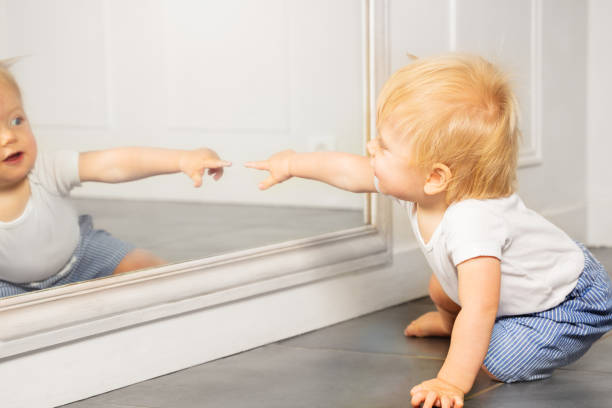 istock Blond toddler boy point to the mirror with finger 1316956264