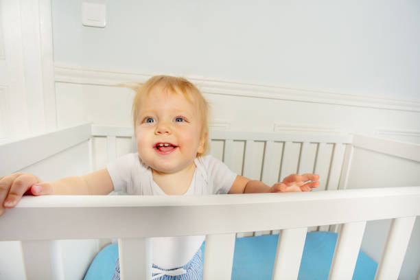 istock Baby boy stand in the crib with happy expression 1316956266