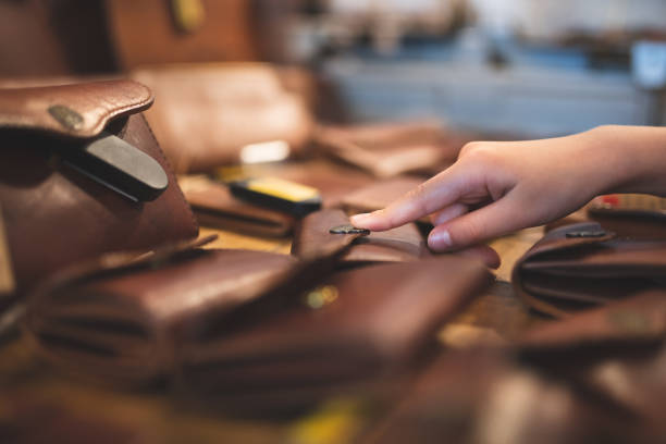 istock Child's hand choosing a leather wallet 1316958478