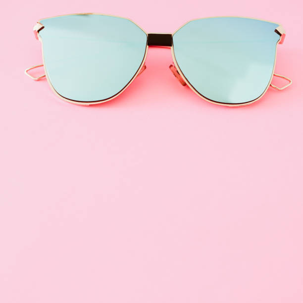 istock Pale blue sunglasses on a pastel pink background. 1316959684