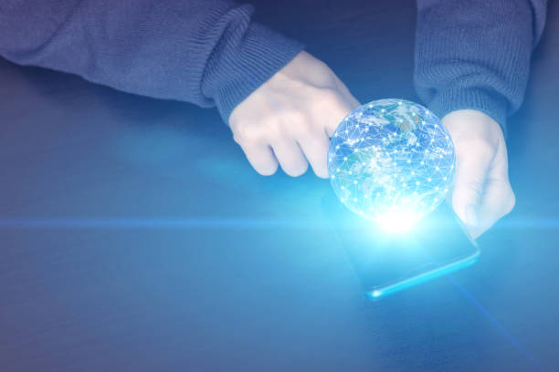 istock global network business technology communication concept, hands with mobile phone and planet globe, Element of the image provided by NASA 1316961177