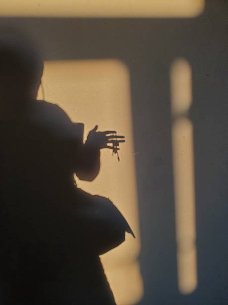 istock Defocus shadowy silhouette holding bunch of keys in hand 1316962201