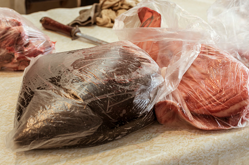 Pig's blood in a plastic bag next to other pork portions at a local market. Raw ingredient for Dinuguan, a Filipino recipe.