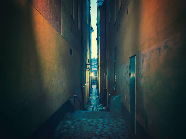 Dark narrow alley A dark narrow alley in the evening. Gamla Stan, Stockholm. alley stockholm old town narrow stock pictures, royalty-free photos & images