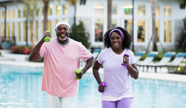 istock Senior African-American couple exercising on pool deck 1316963772