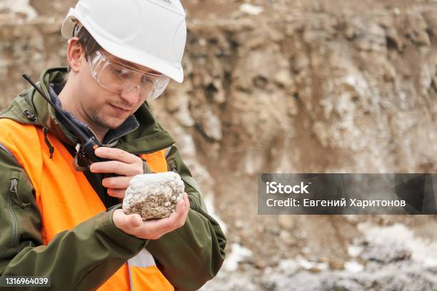 Geologist Examines A Mineral Sample Stock Photo - Download Image Now - Geology, Mining - Natural Resources, Geologist
