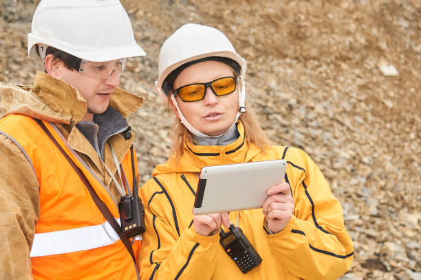 mining engineers discussing working documentation at the mining site mining engineers discussing working documentation outdoor at the mining site geologist stock pictures, royalty-free photos & images