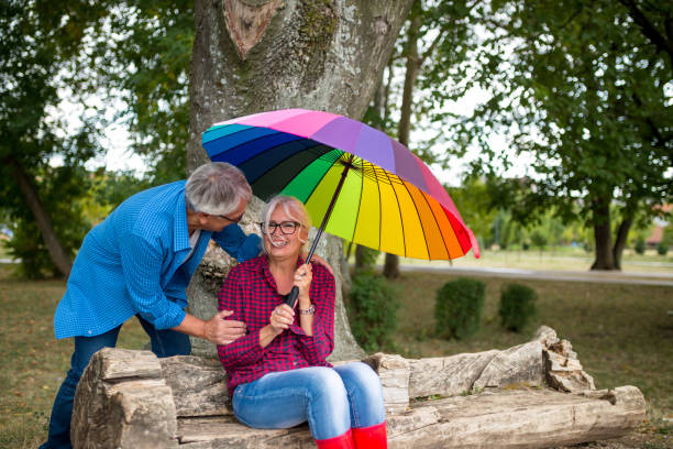 istock Couple under umbrella in autumn park 1316965950
