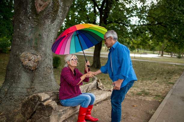istock Couple under umbrella in autumn park 1316965973