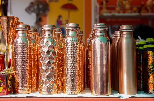 Copper bottle on display in store ay hunar haat craft fair.